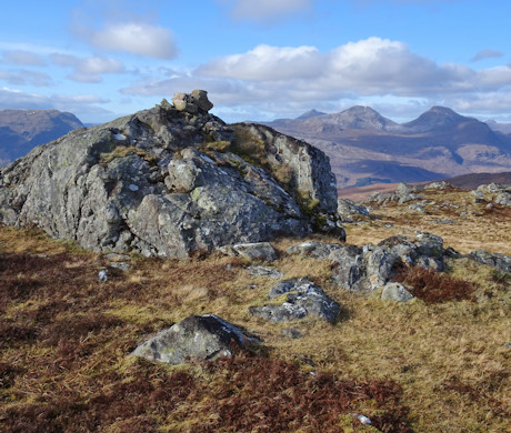 Summit of Creag Dhubh Mhòr with the mountains of Coulin beyond