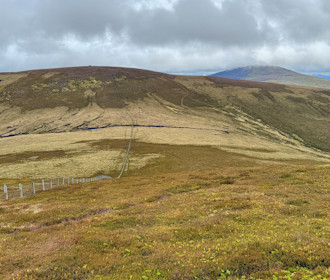 Path aside fenceline leading to Mona Gowan, Morven behind